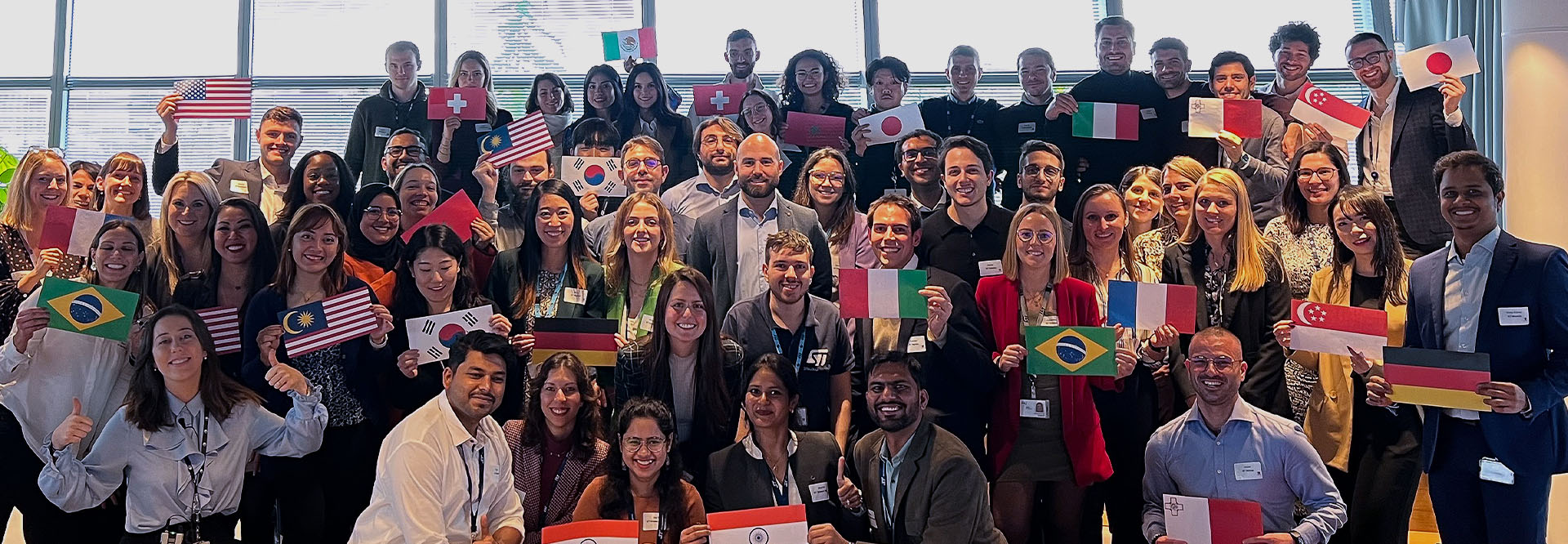 A group of people holding flags from around the world (photo)